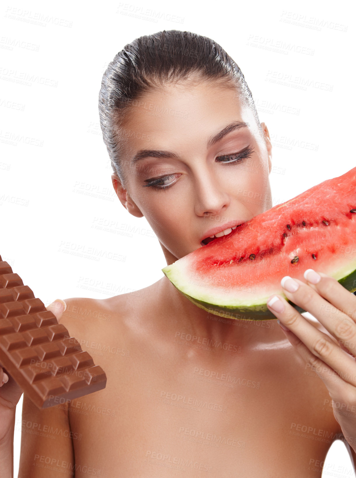 Buy stock photo Studio shot of a young woman eating a slice of watermelon while eying out a slab of chocolate