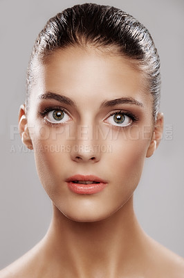 Buy stock photo Studio portrait of a beautiful young woman against a gray background