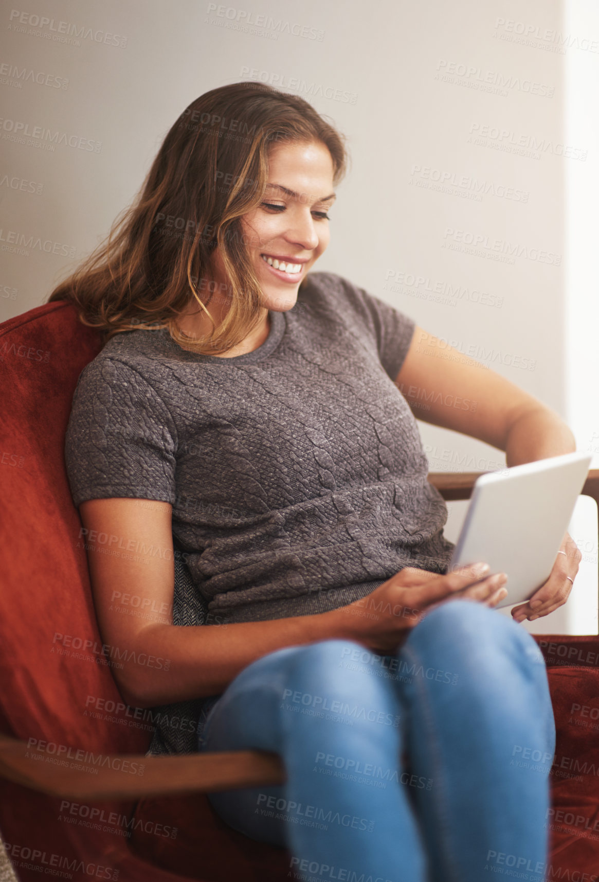 Buy stock photo Shot of a young woman relaxing with a digital tablet at home