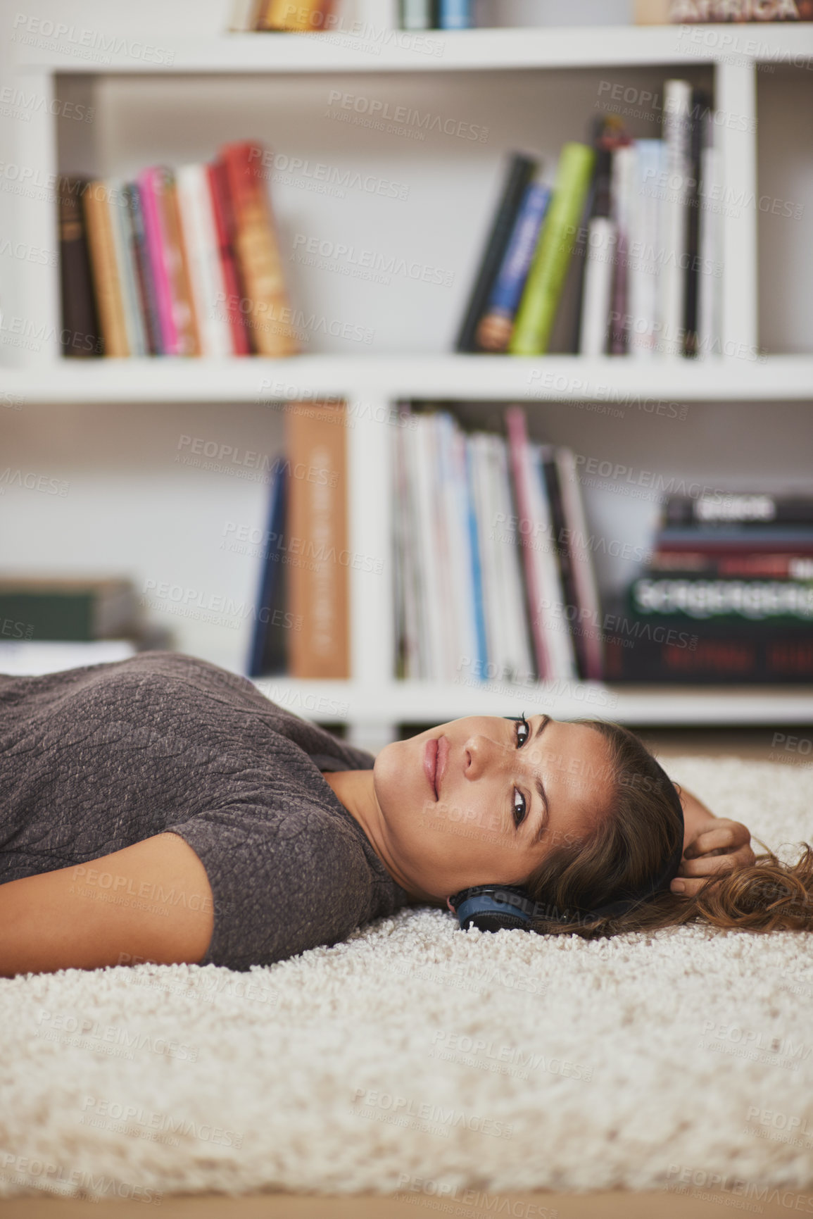 Buy stock photo Portrait of a young woman relaxing at home and listening to music
