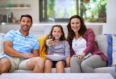 Buy stock photo Happy, family and television on sofa with popcorn for watching movie, series and smile for streaming show. Parents, child and remote with snack in home for entertainment, relax and bonding on couch