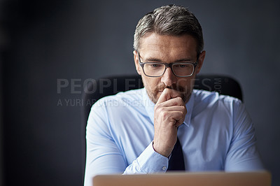 Buy stock photo Cropped shot of a mature businessman working in his office