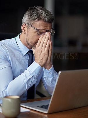 Buy stock photo Cropped shot of a mature businessman looking anxious while working in his office