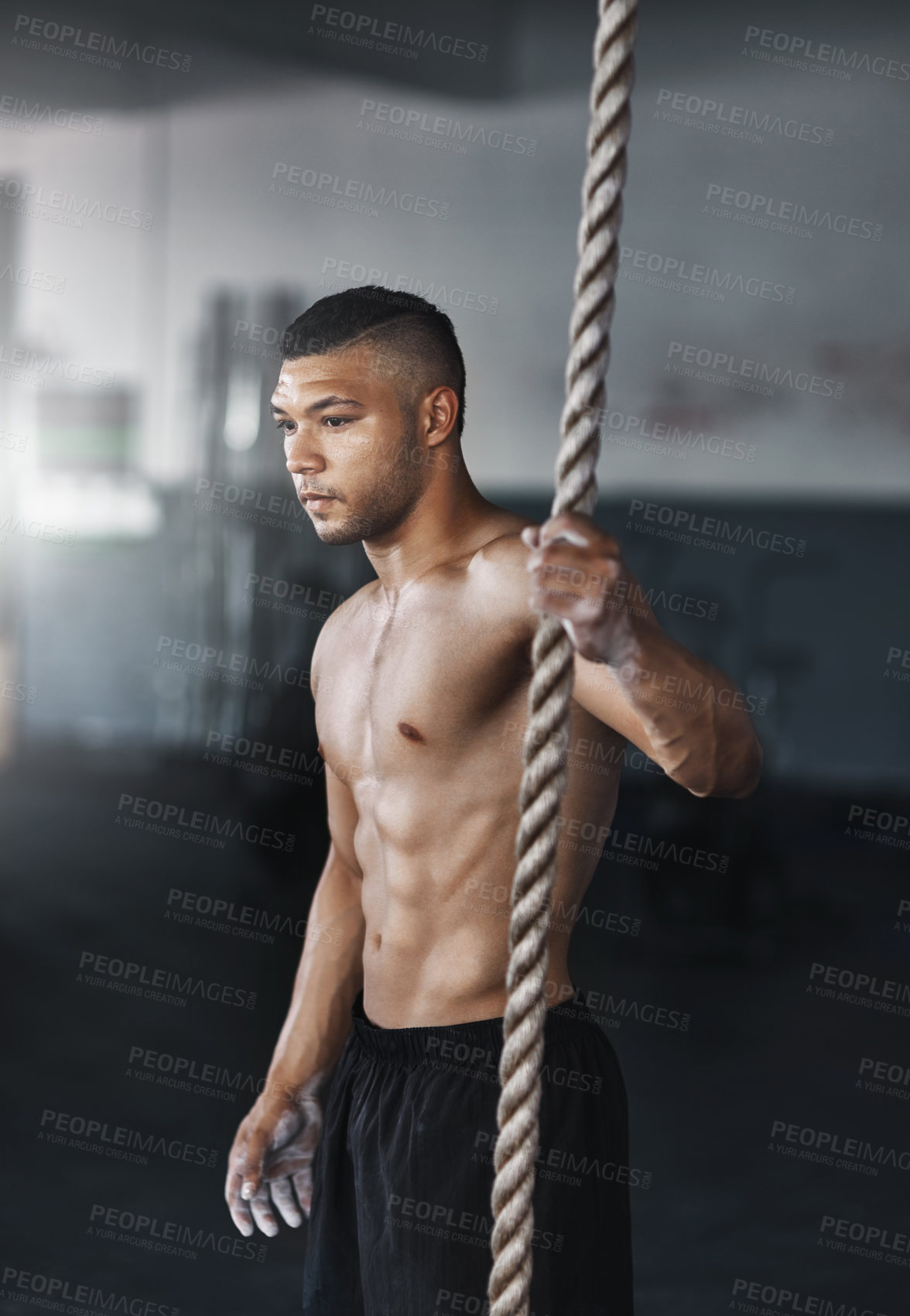 Buy stock photo Training, climbing rope and man in gym, serious and exercise for stamina, strong and balance for body. Healthy, thinking and athlete in club for muscle, sportswear and ready for competition or person