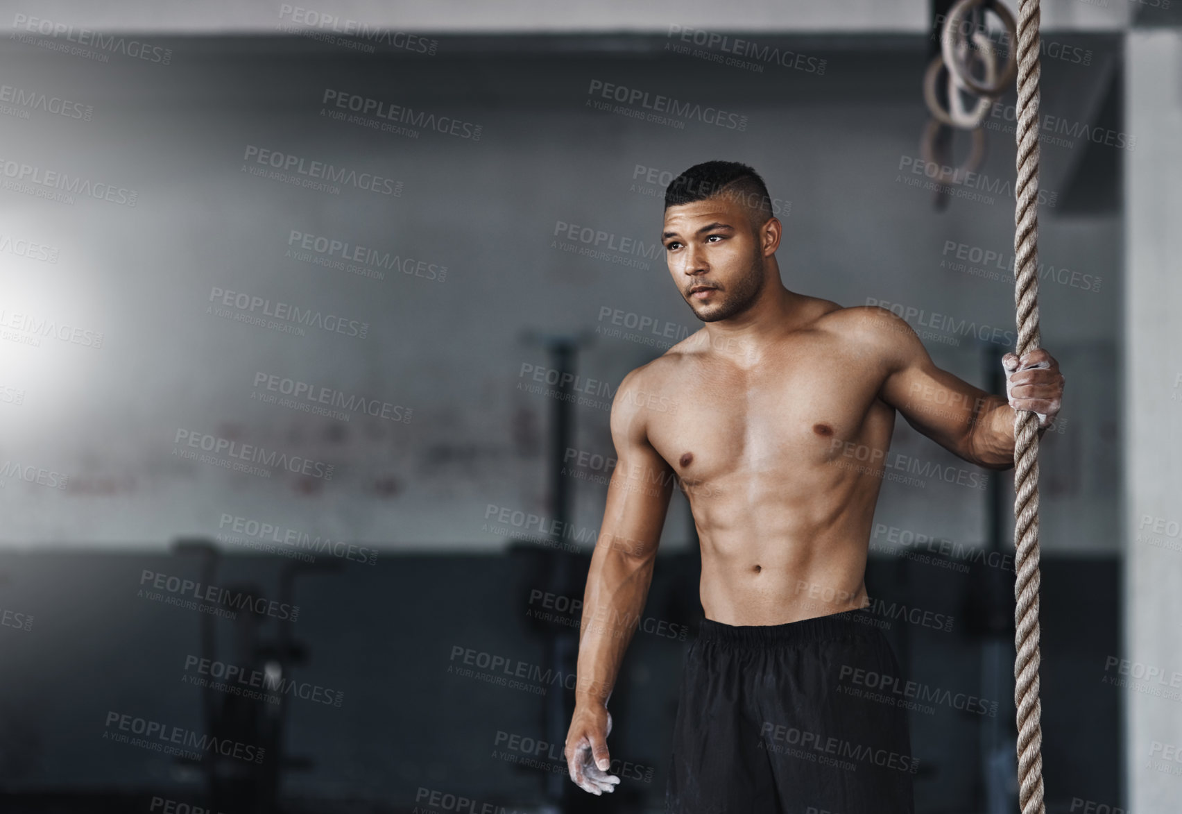 Buy stock photo Shot of a young athlete working out in the gym