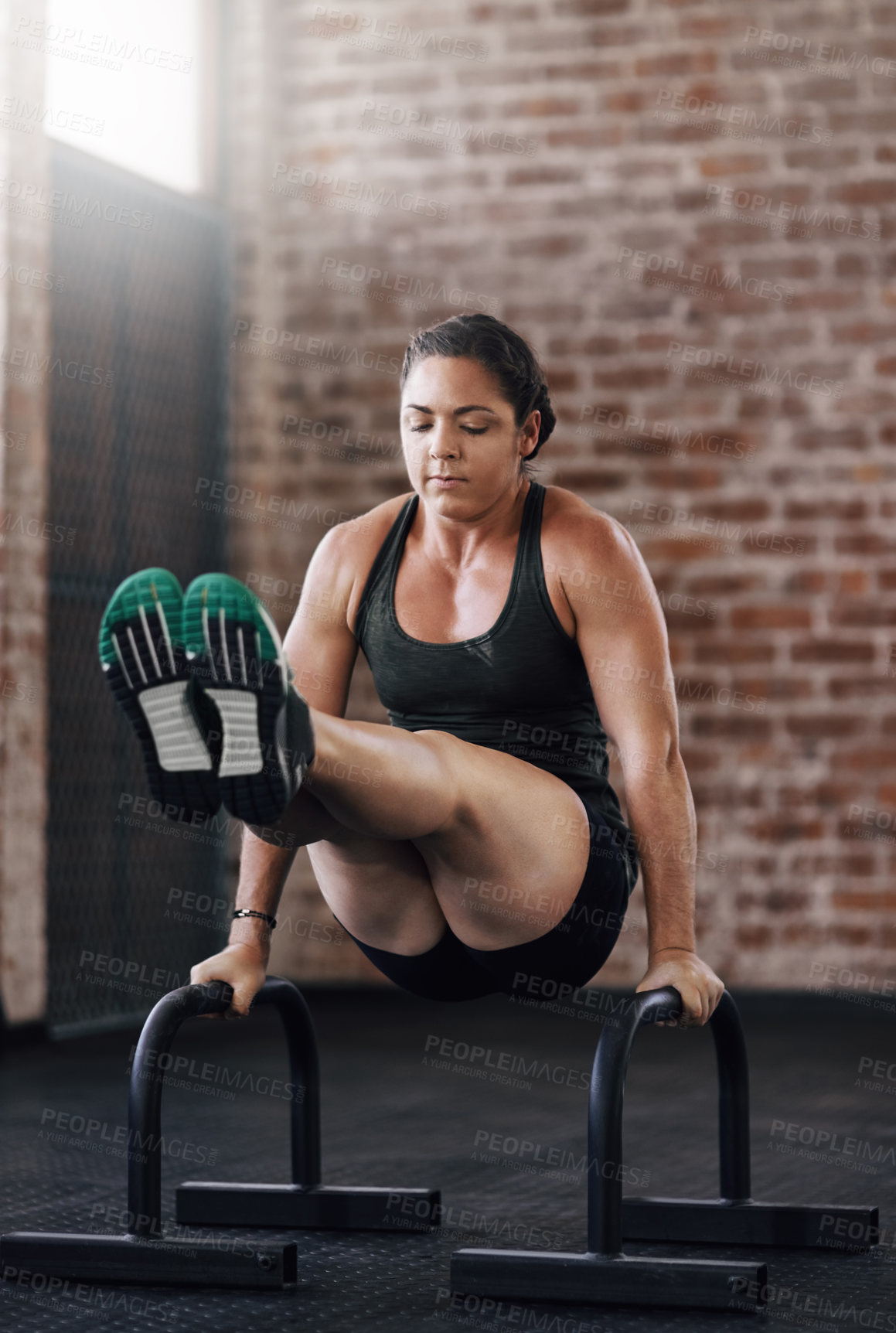 Buy stock photo Full length shot of a young woman working out in the gym