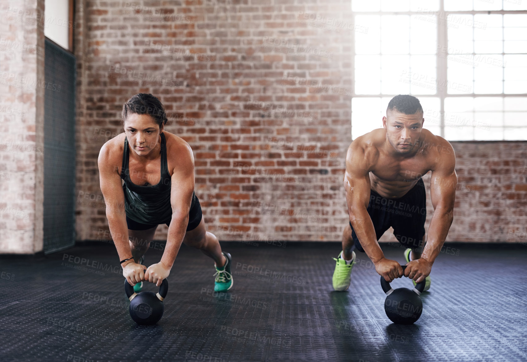 Buy stock photo Full length shot of two young athletes working out in the gym