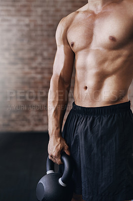 Buy stock photo Cropped shot of a young man working out in the gym