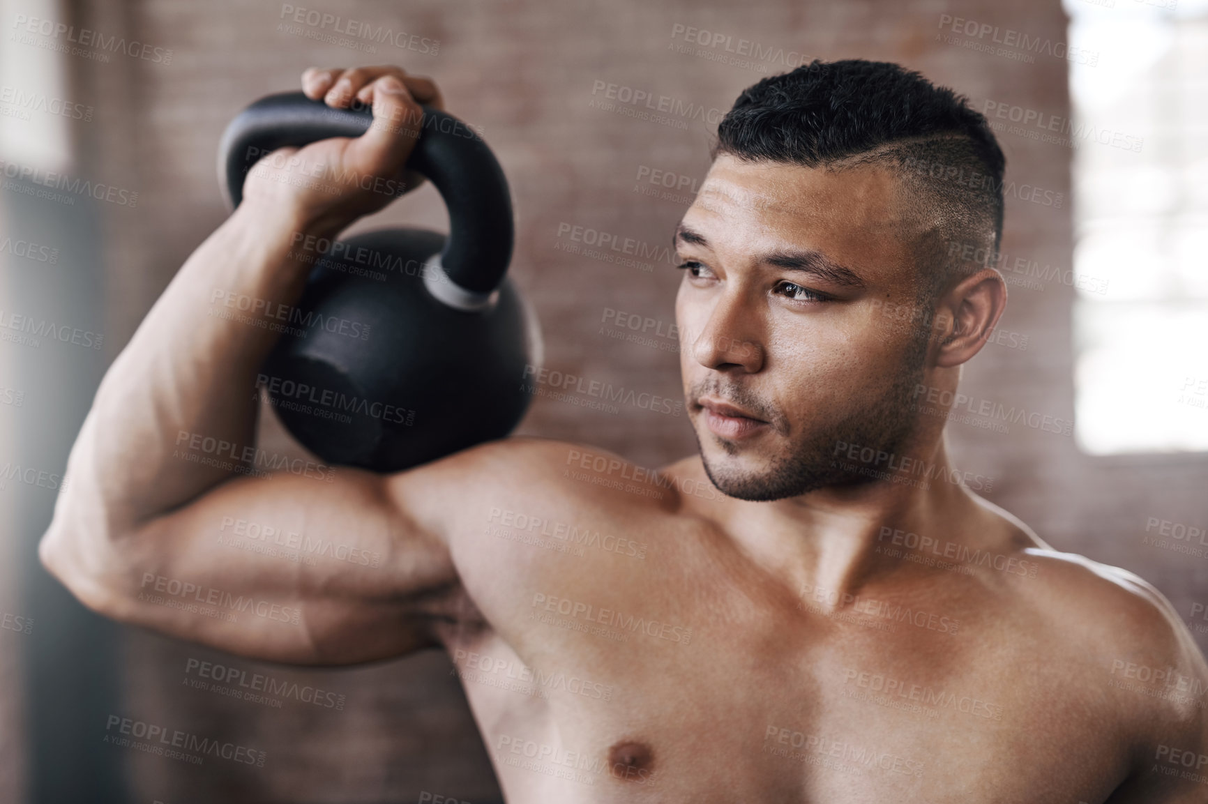 Buy stock photo Workout, strong and man with kettlebell in gym for muscle development, weightlifting or endurance challenge. Energy, shirtless and athlete for bodybuilding, fitness routine or performance exercise