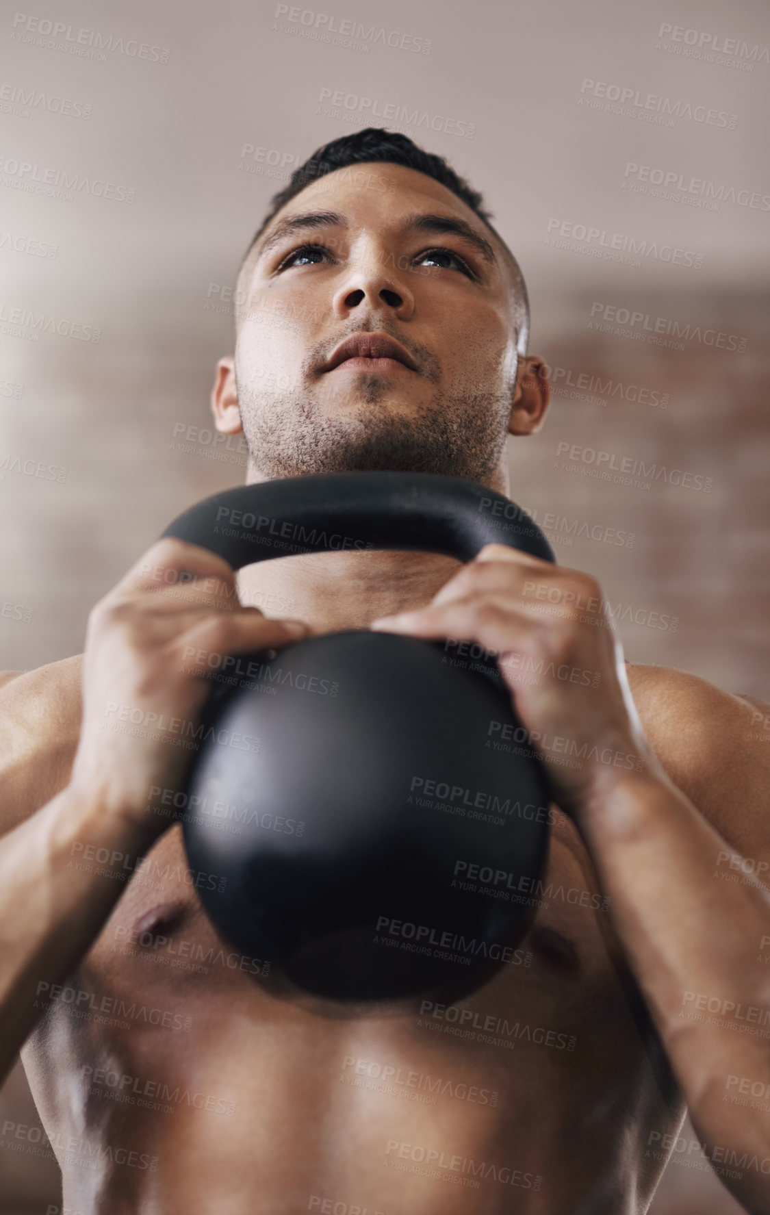 Buy stock photo Cropped shot of a young man working out in the gym