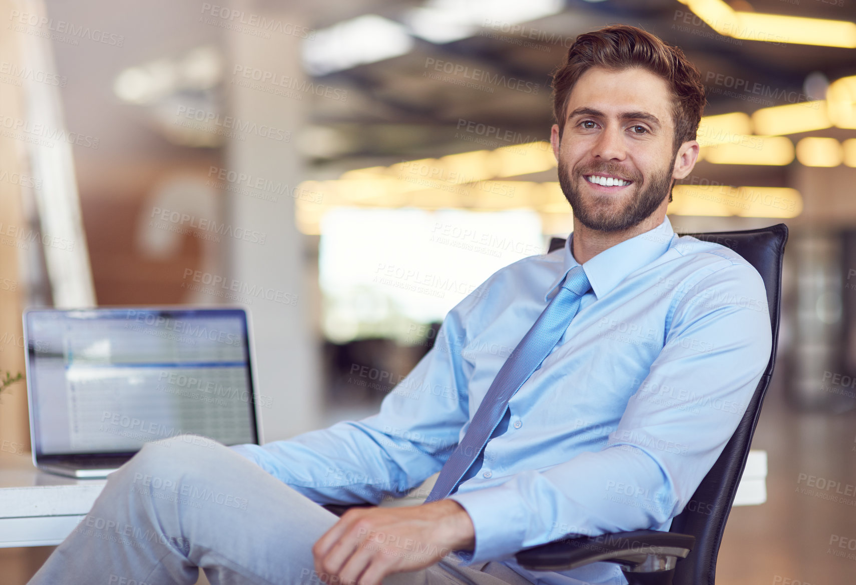 Buy stock photo Portrait of a young businessman sitting at his desk in an office