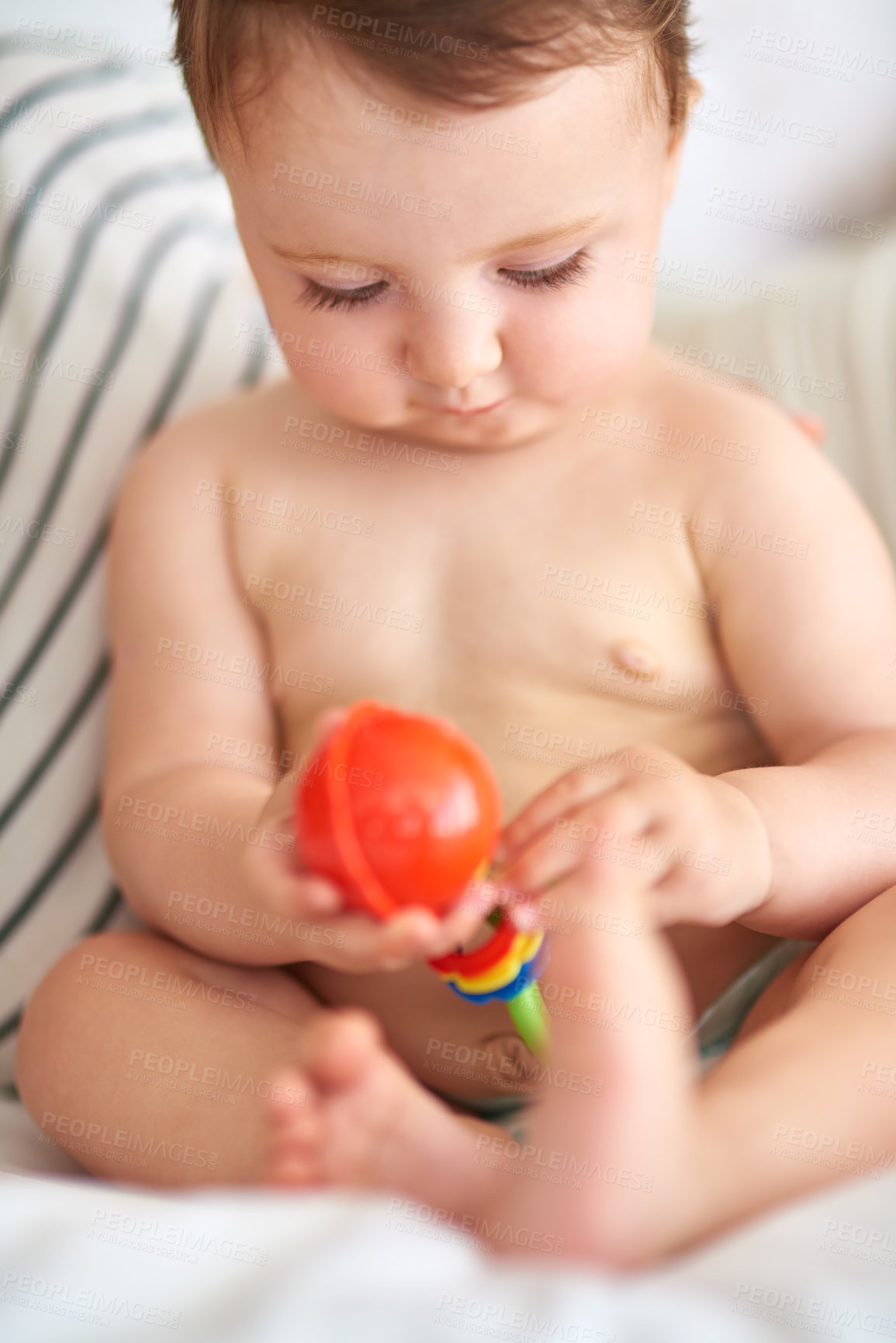 Buy stock photo Cropped shot of an adorable baby girl playing with a toy