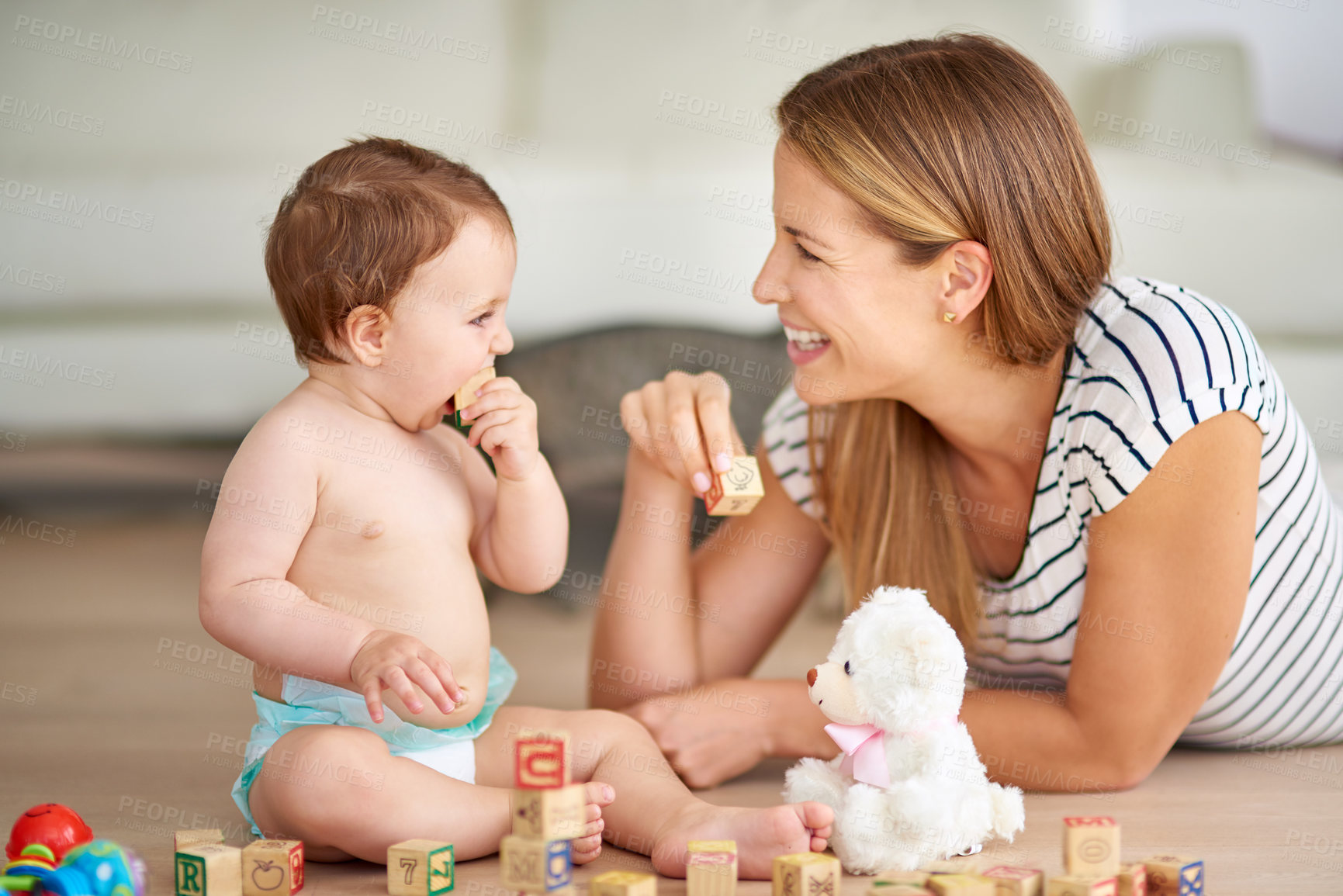 Buy stock photo Shot of an adorable baby girl and her mother playing with wooden blocks at home