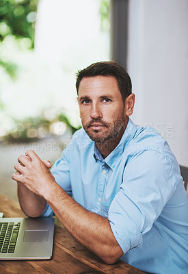 Buy stock photo Cropped portrait of a businessman working on his laptop at home