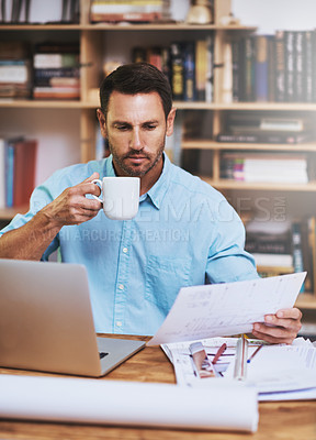 Buy stock photo Cropped shot of a businessman reading some paperwork at home