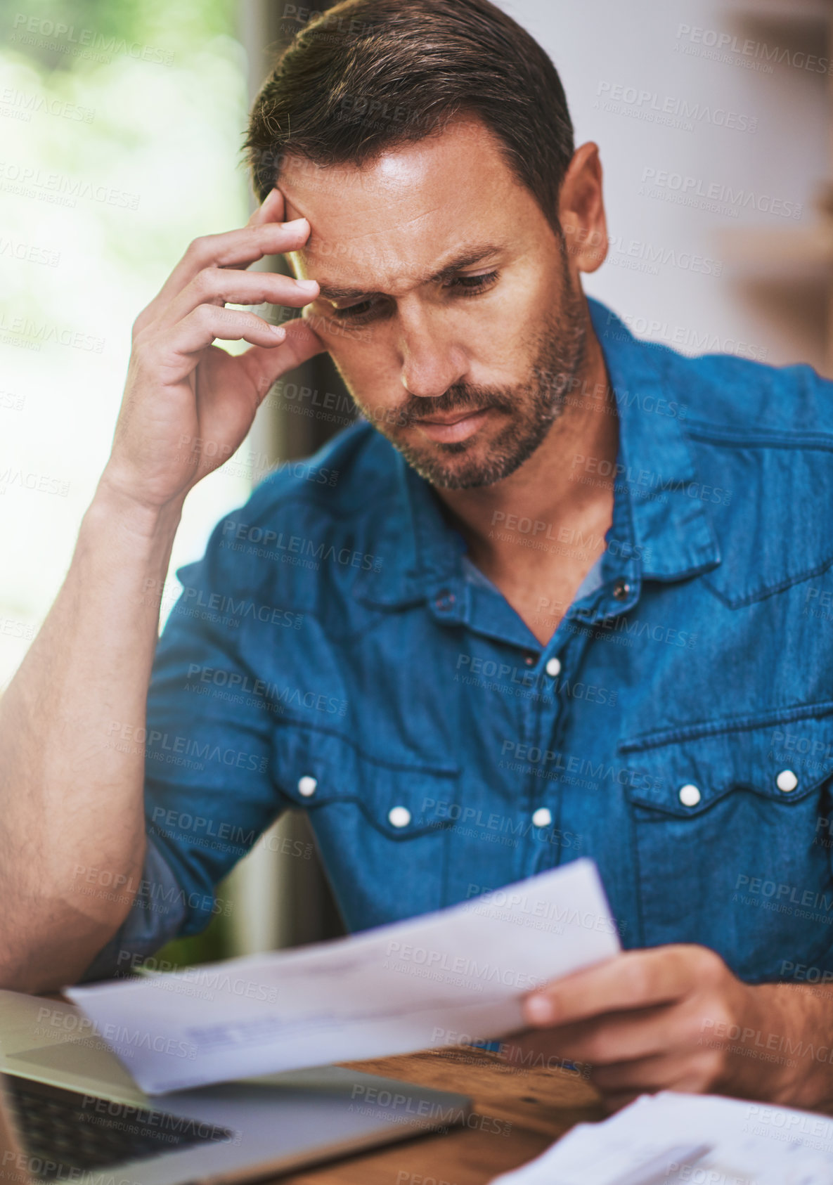 Buy stock photo Man, stress and tired for paperwork burnout in home office, reading report and anxiety for tax audit. Male person, frustrated and documents for remote work, mental health and letter mistake or crisis