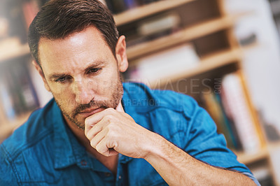 Buy stock photo Cropped shot of a businessman looking thoughtful while working at home