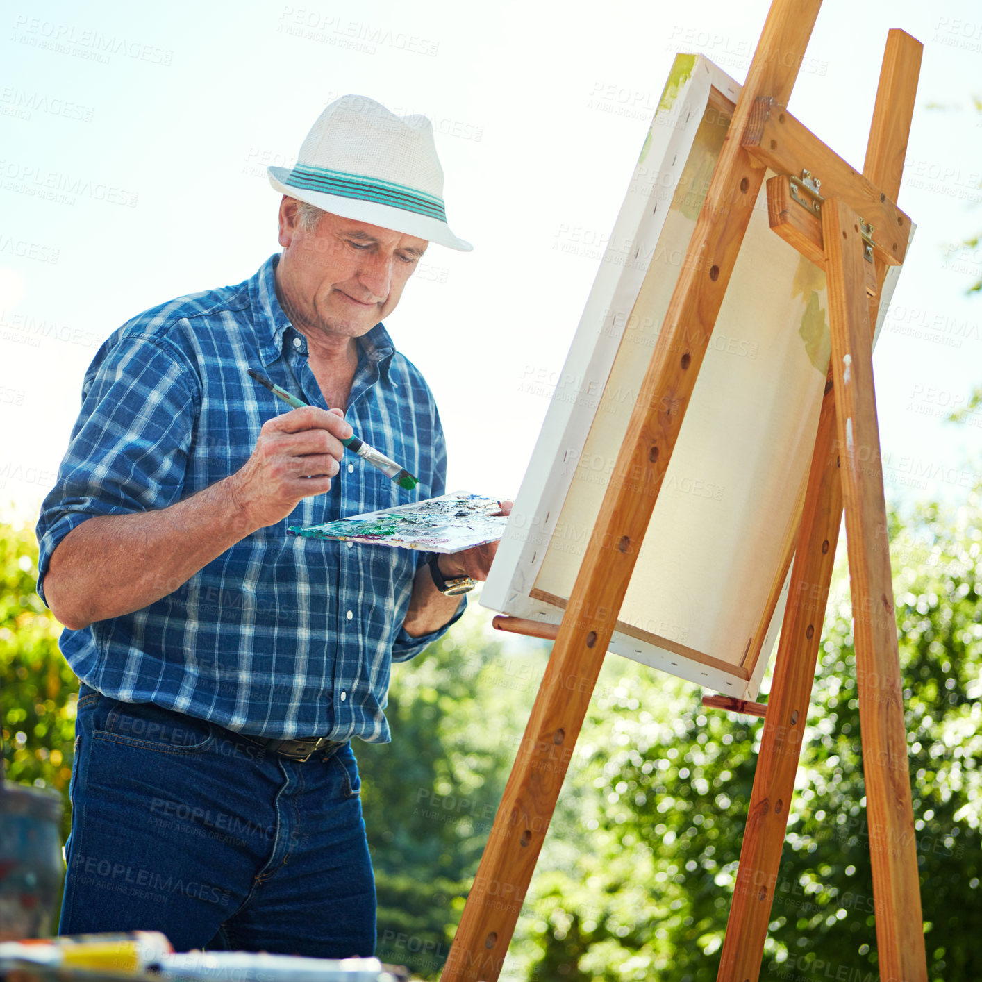 Buy stock photo Cropped shot of a senior man painting in the park