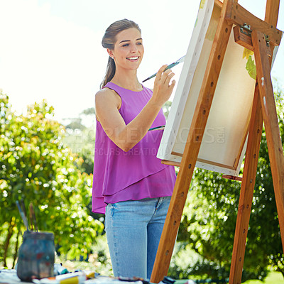 Buy stock photo Cropped shot of a young woman painting in the park