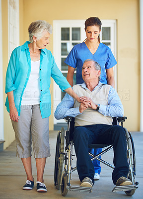 Buy stock photo Wife, caregiver or old man talking in wheelchair in hospital clinic helping an elderly patient for support. Disabled, couple or trusted healthcare nurse speaking with senior people with a disability