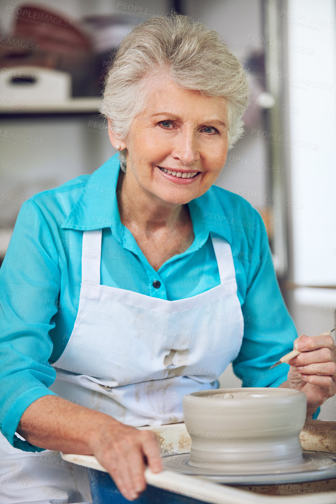 Buy stock photo Portrait of a senior woman making a ceramic pot in a workshop