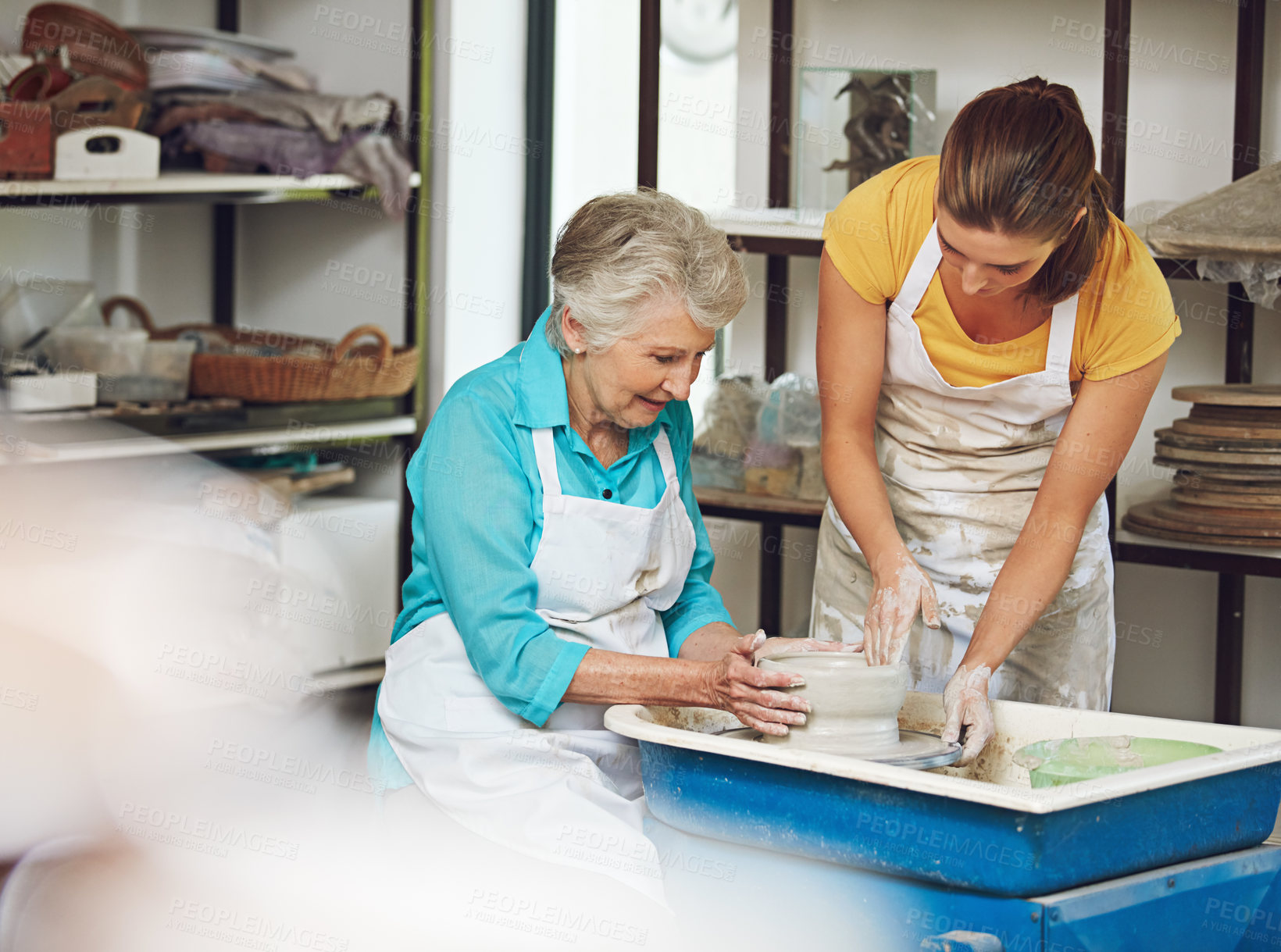 Buy stock photo Shot of a senior woman making a ceramic pot at a pottery class