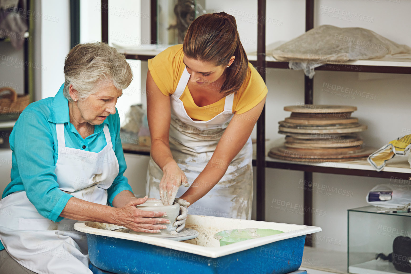 Buy stock photo Shot of a senior woman making a ceramic pot at a pottery class