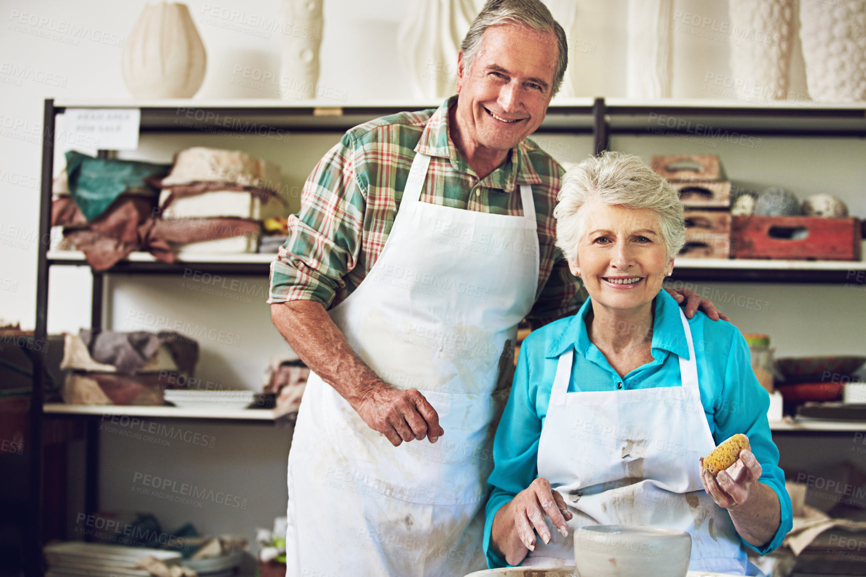 Buy stock photo Portrait of a senior couple making a ceramic pot together in a workshop
