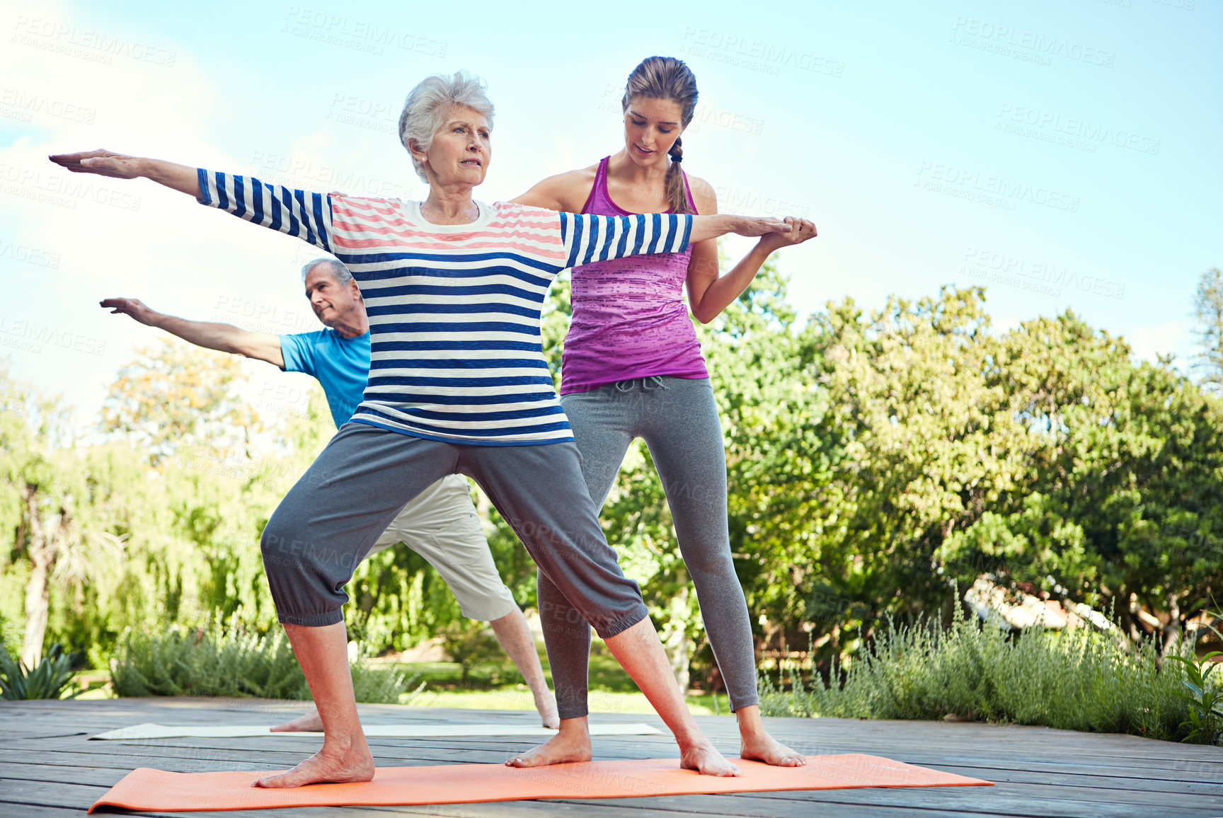 Buy stock photo Nature, elderly people and yoga coach, woman or personal trainer teaching exercise, outdoor workout or fitness. Instructor, wellness couple and old person learning pilates, training or health balance