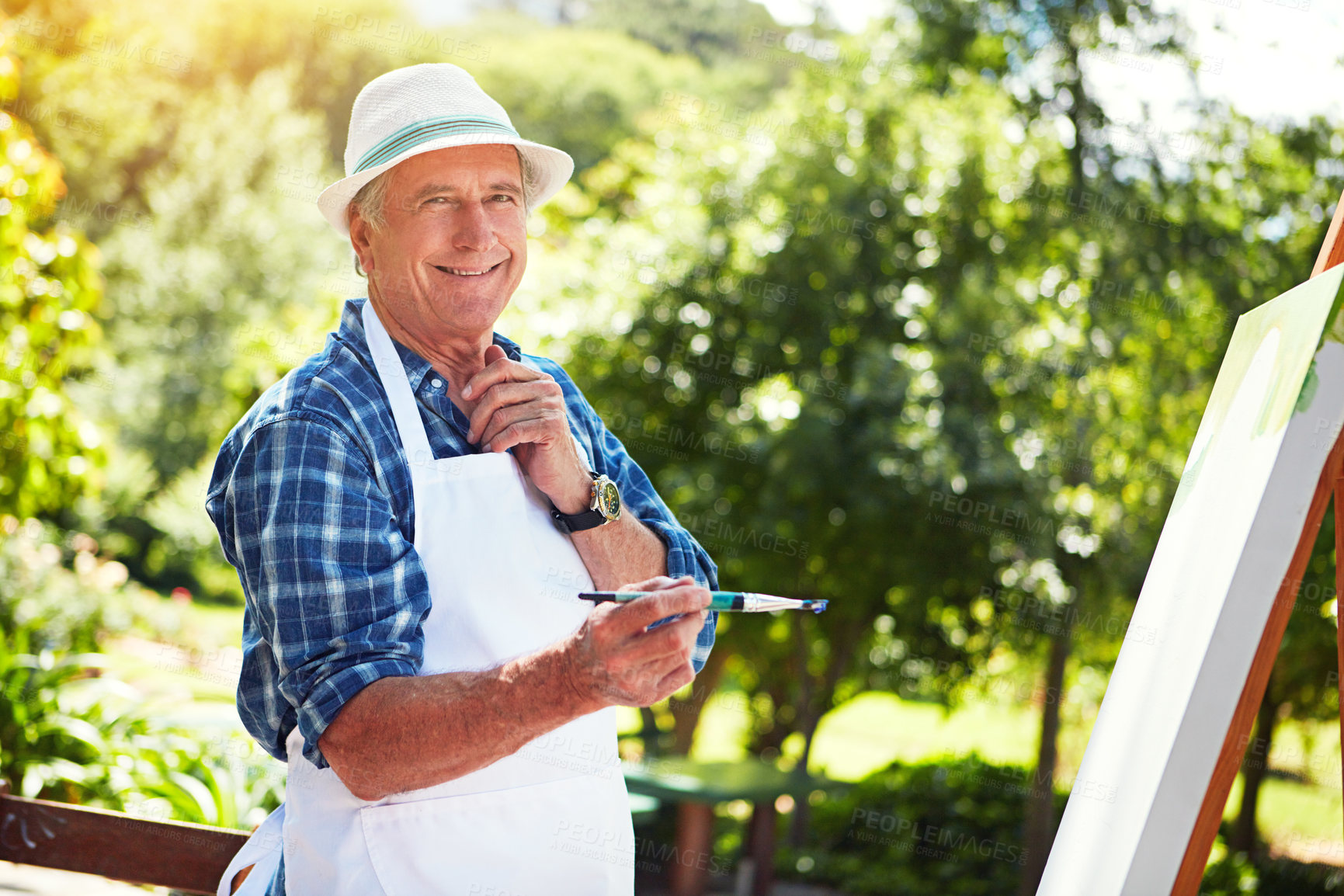 Buy stock photo Cropped portrait of a senior man painting in the park