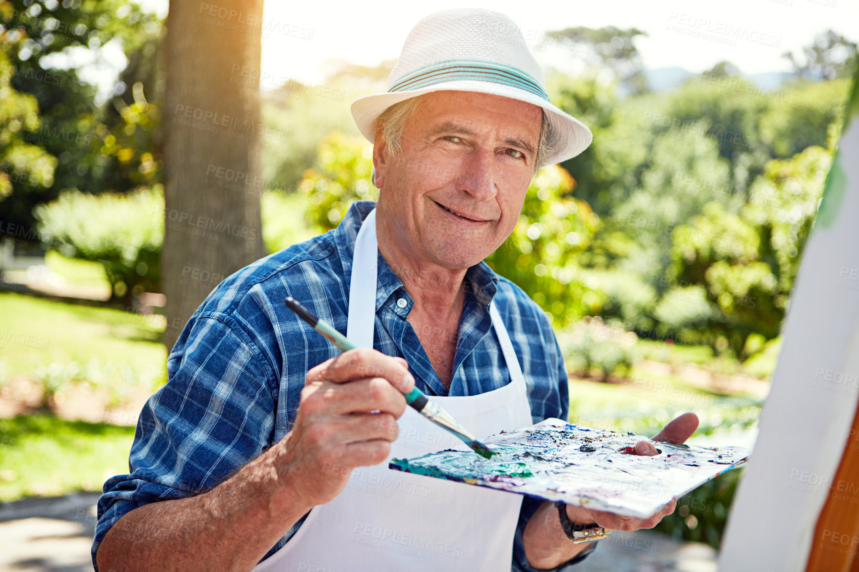 Buy stock photo Cropped portrait of a senior man painting in the park