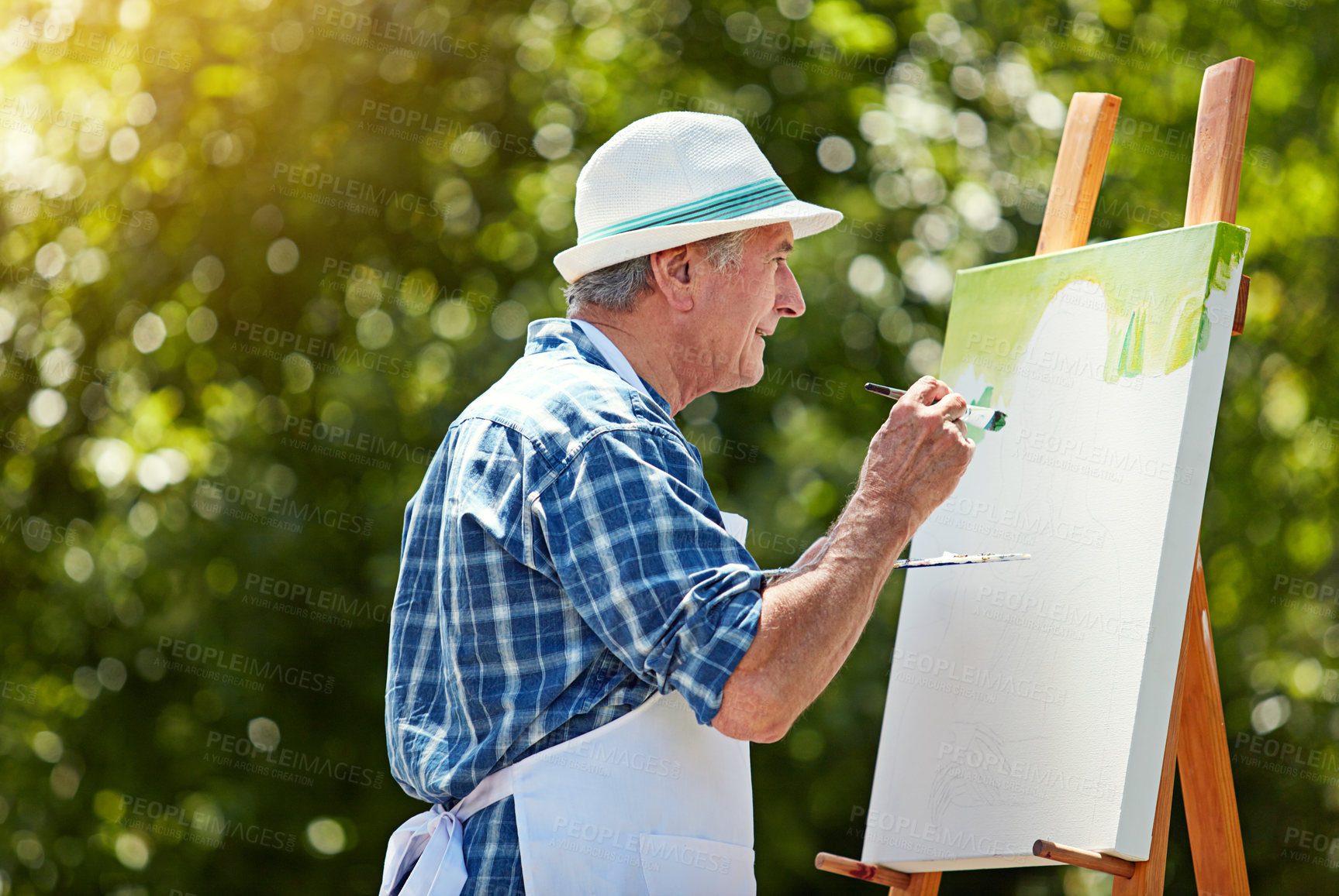 Buy stock photo Cropped shot of a senior man painting in the park