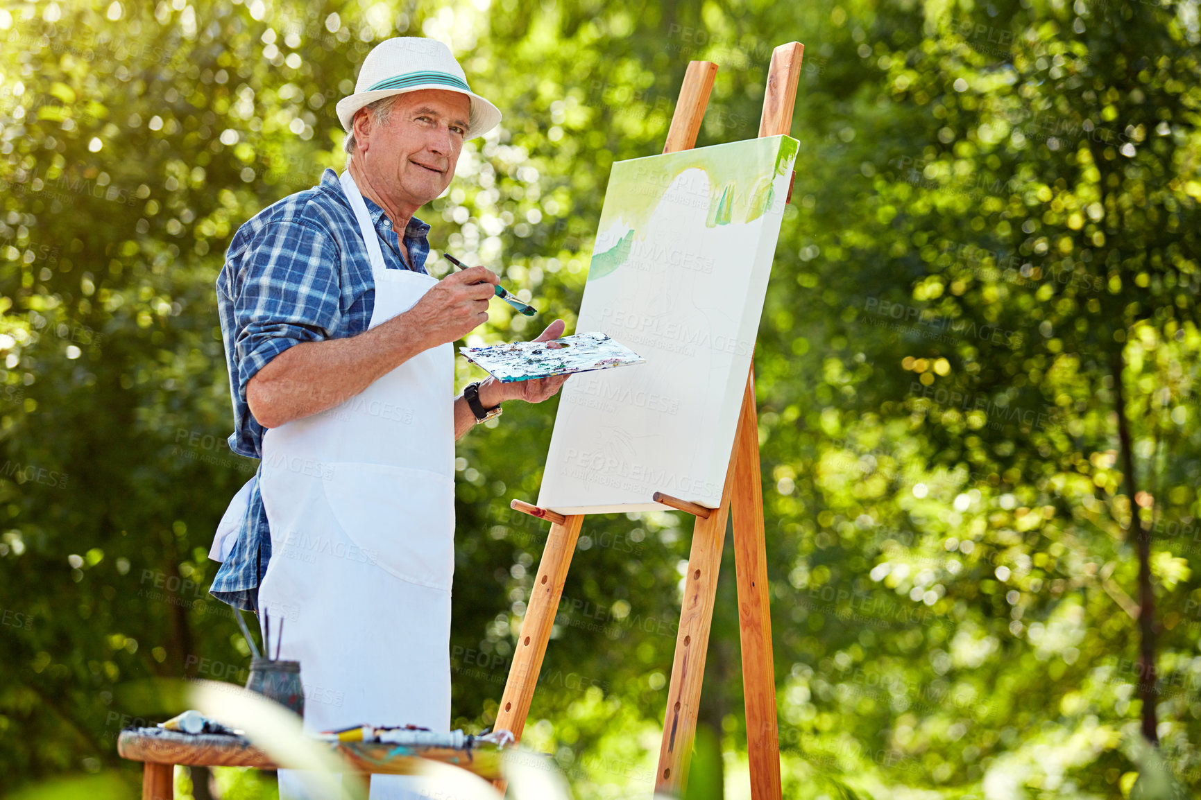 Buy stock photo Cropped shot of a senior man painting in the park