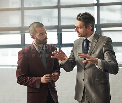 Buy stock photo Shot of two businessmen having a discussion