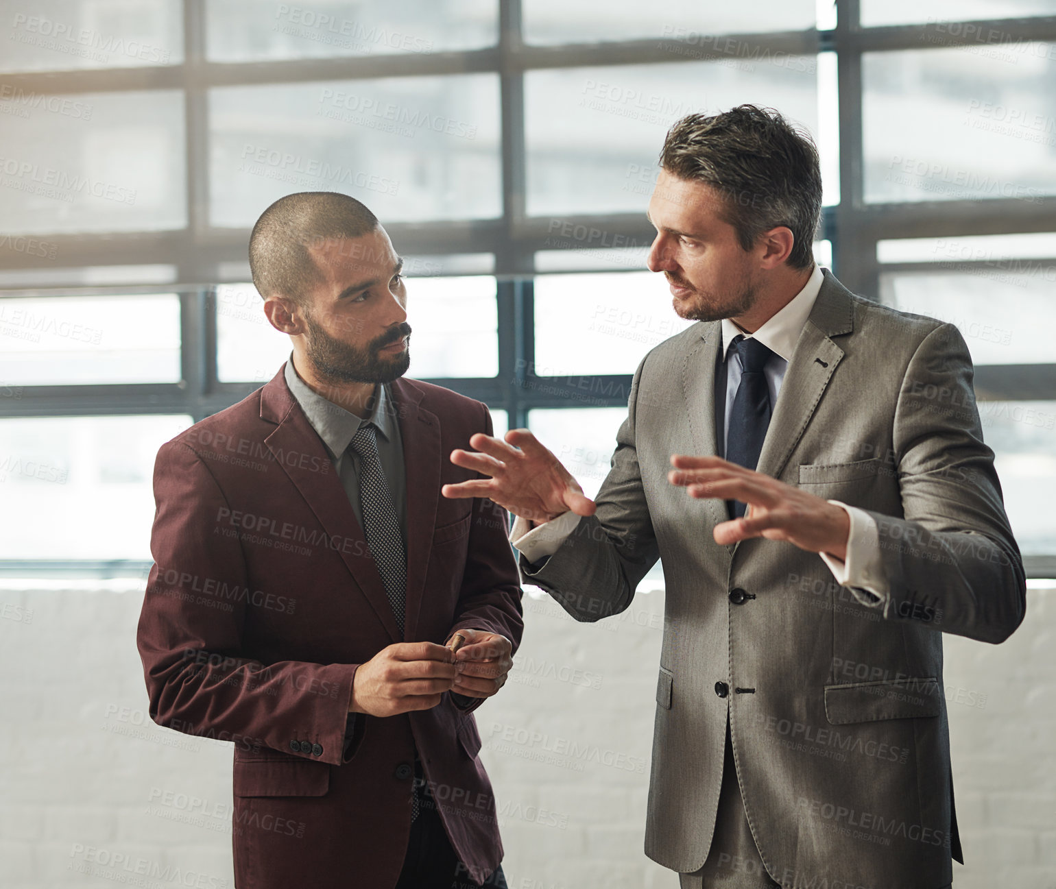 Buy stock photo Shot of two businessmen having a discussion