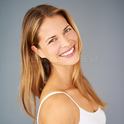 Buy stock photo Studio shot of an attractive young woman posing against a gray background