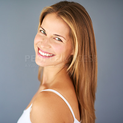Buy stock photo Studio shot of an attractive young woman posing against a gray background