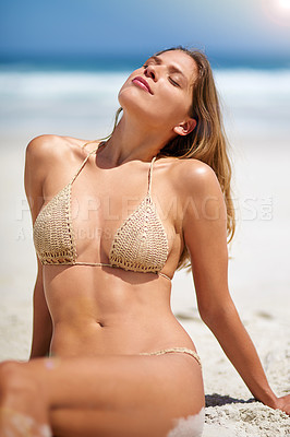Buy stock photo Cropped shot of a young woman relaxing at the beach