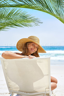 Buy stock photo Rearview portrait of a young woman relaxing at the beach