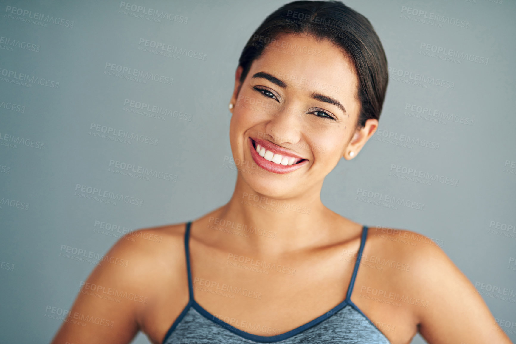 Buy stock photo Cropped shot of a sporty young woman posing against a grey background