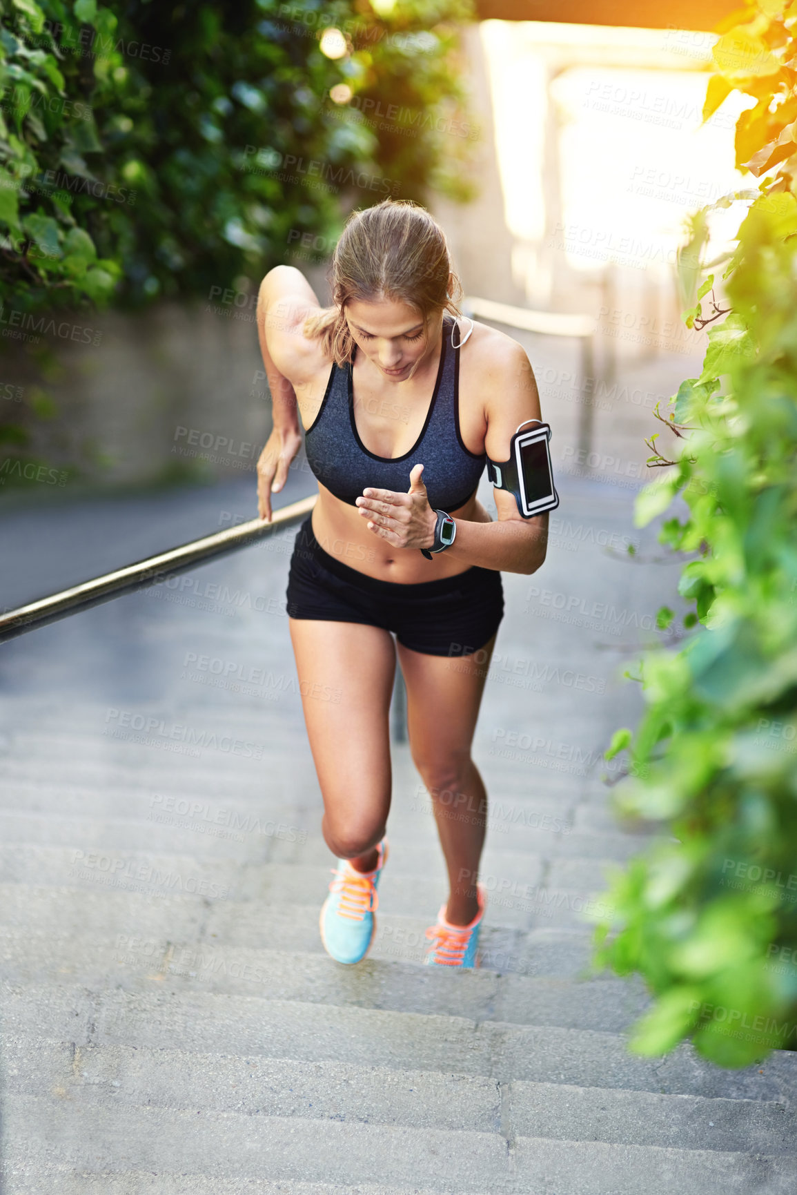 Buy stock photo Woman, earphones and stairs and run for workout, endurance and outside for cardio health. Fitness, sports or steps with cellphone for training with audio or music, athlete person or streaming podcast