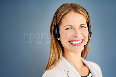 Buy stock photo Studio shot of a successful businesswoman against a blue background 