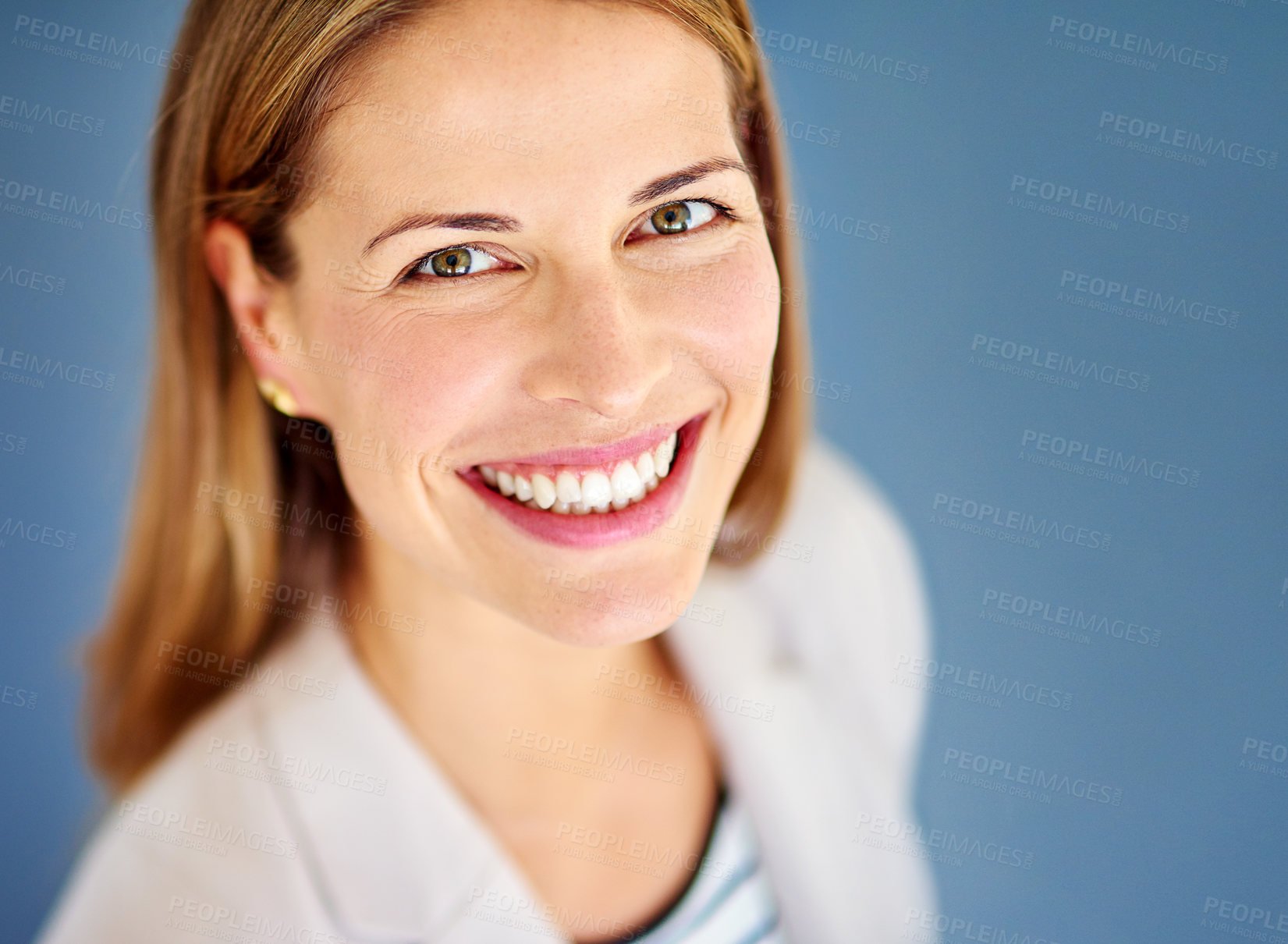 Buy stock photo Shot of a woman dressed in office-wear posing against a blue background