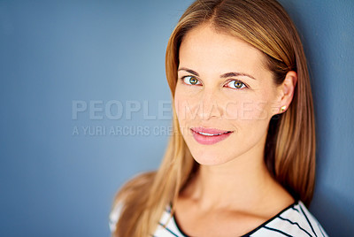 Buy stock photo Studio shot of a successful businesswoman against a blue background 