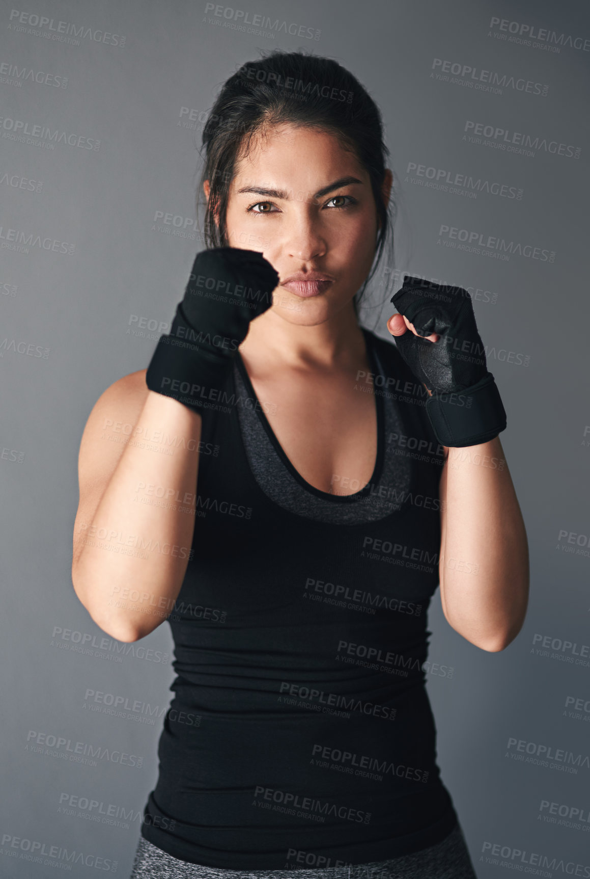 Buy stock photo Studio shot of a female kickboxer against a gray background