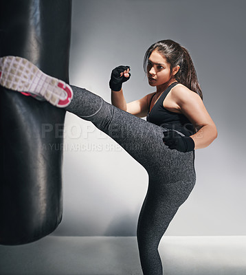 Buy stock photo Studio shot of a female kickboxer against a gray background