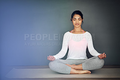 Buy stock photo Shot of an attractive young woman meditating