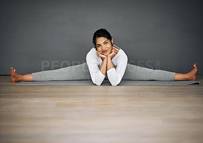 Buy stock photo Portrait of an attractive young woman doing the splits in her yoga routine