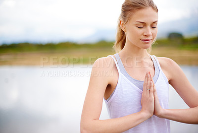 Buy stock photo Cropped shot of a sporty young woman holding her hands in prayer position