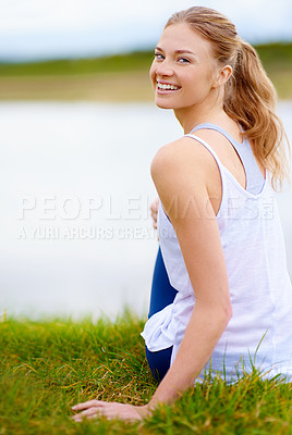 Buy stock photo Shot of a young woman sitting outdoors